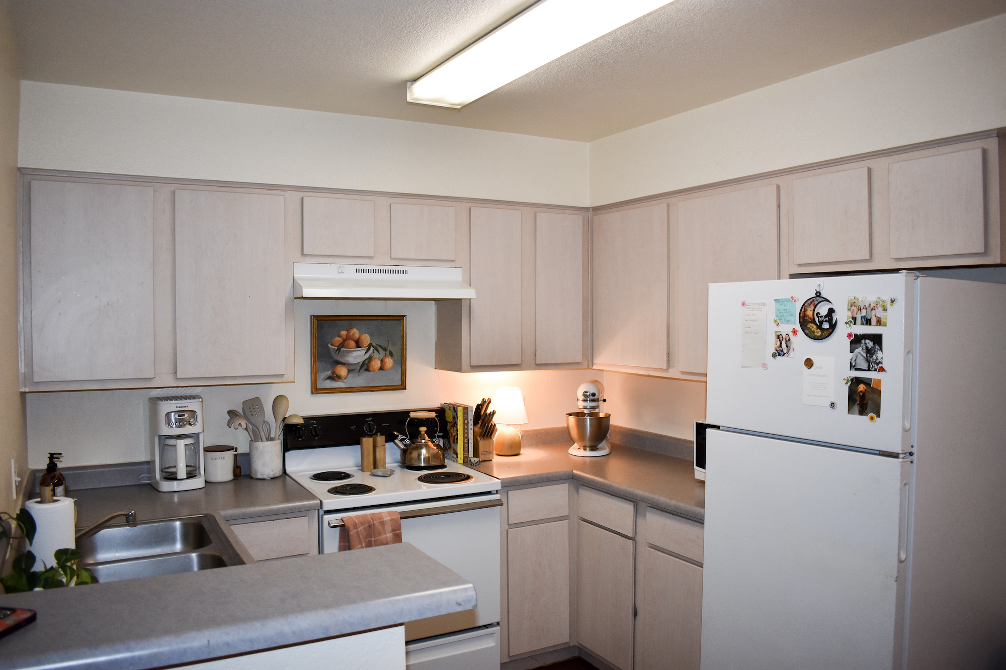 Entering kitchen area with light finishes and warm home decor