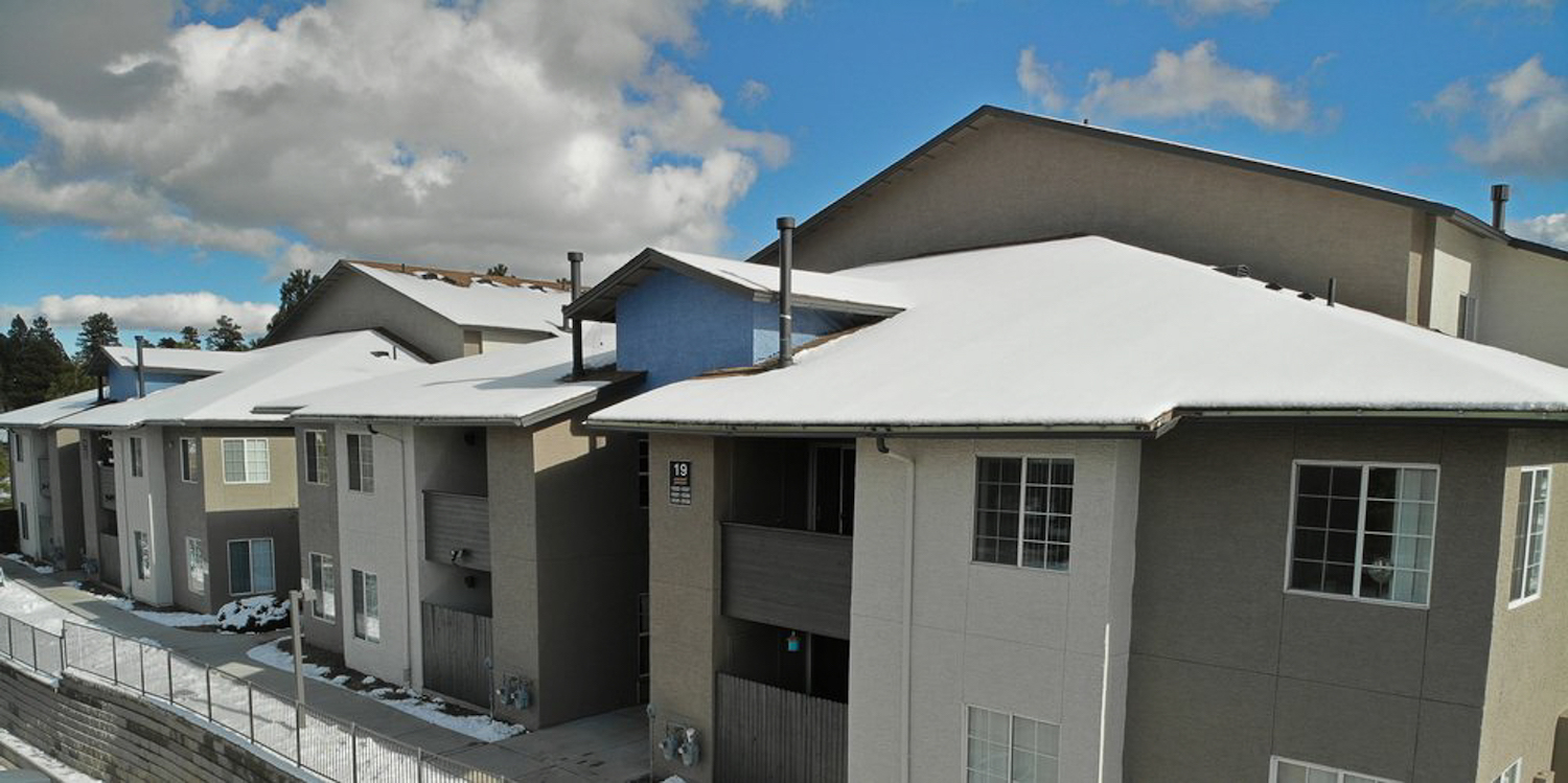 Outside view of apartment complex with snowy rooftops