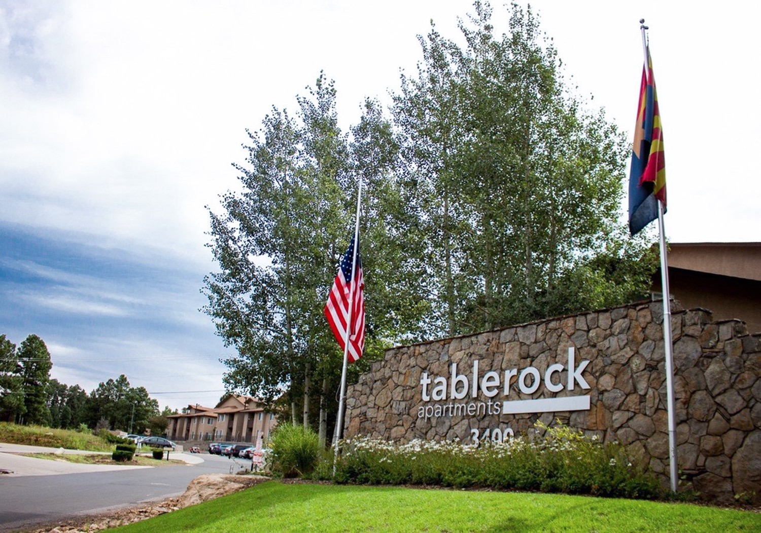 Welcoming apartment sign at entrance of community